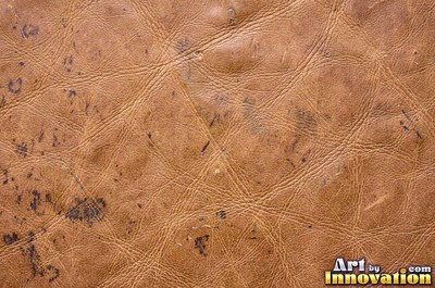 Old cracked leather with a crazed surface in whiskey brown