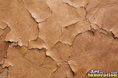 Old cracked leather with a crazed surface in whiskey brown