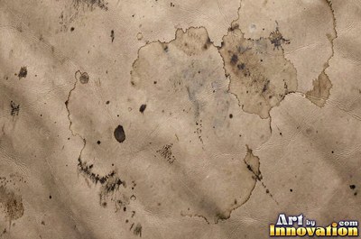 Worn saddle tan leather scuffed pale along the creases