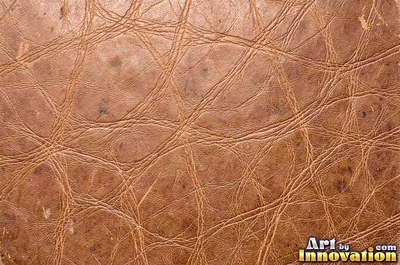Burgundy leather marked with water stains and dark spots