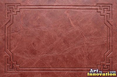 Tooled leather carved with a floral scroll in oxblood red