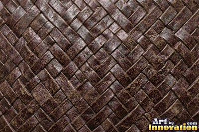 Tooled leather carved with a floral scroll in oxblood red
