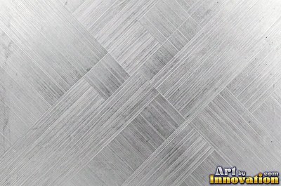 Coarse brushed finish with deep grain lines in dark gunmetal