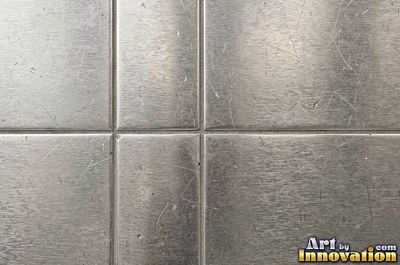 Cross hatched brushed metal in warm burnished brass