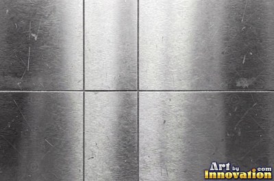 Coarse brushed finish with deep grain lines in dark gunmetal