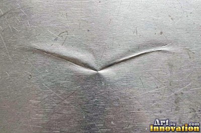 Cross hatched brushed metal with two sets of fine lines in pewter