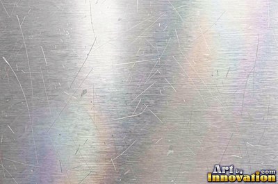 Coarse brushed finish with deep grain lines in dark gunmetal