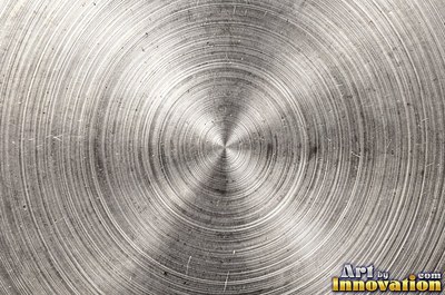 Coarse brushed finish with deep grain lines in dark gunmetal