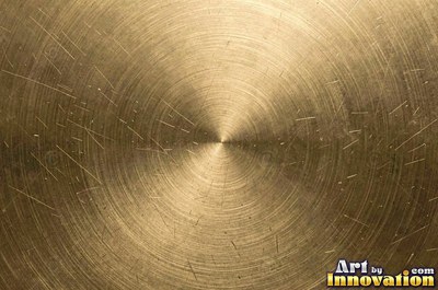Coarse brushed finish with deep grain lines in dark gunmetal