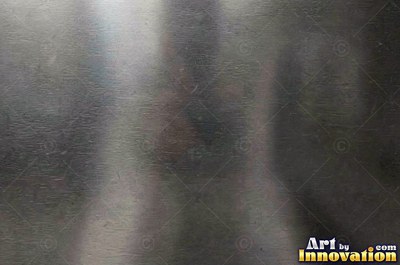 Mirror polished metal reflecting soft abstract gradients of light