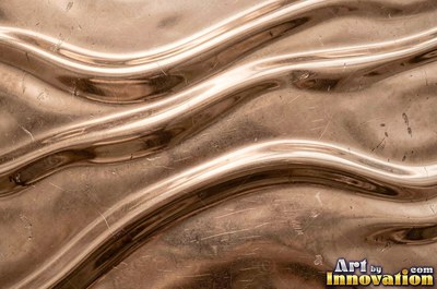 Polished satin chrome with a fine scratch pattern catching the glare