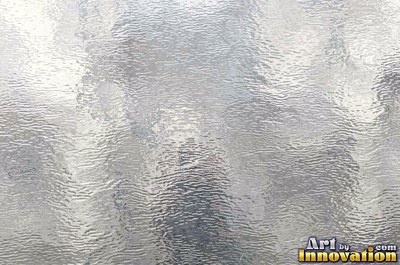 Mirror polished metal reflecting soft abstract gradients of light