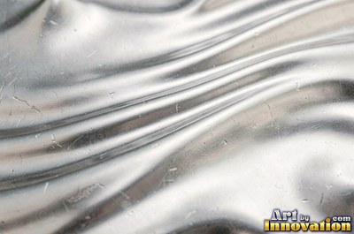 Mirror polished metal reflecting soft abstract gradients of light