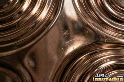 Polished satin chrome with a fine scratch pattern catching the glare