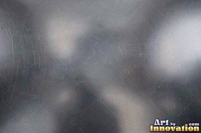 Hammered mirror finish breaking reflections into hundreds of facets