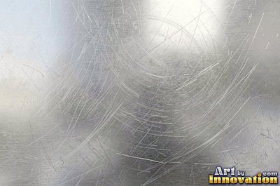 Mirror polished metal reflecting soft abstract gradients of light