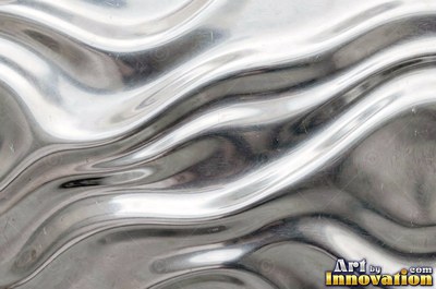 Polished satin chrome with a fine scratch pattern catching the glare