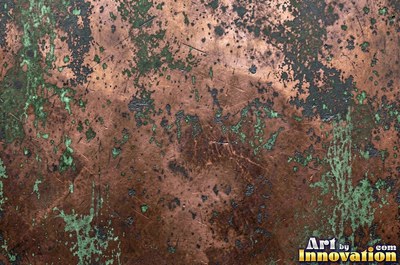 Oxidized copper with a mottled dark surface and bright scratches