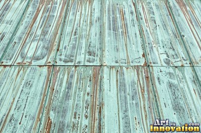 Copper roof panel with drips of patina running down it