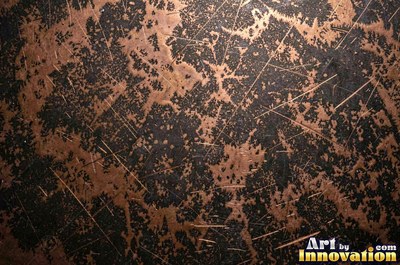 Oxidized copper with a mottled dark surface and bright scratches