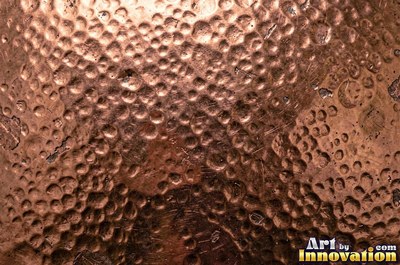Hammered rose copper with dark recesses and bright high points