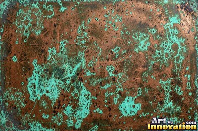 Crusty mint green verdigris built up in thick blooms on copper