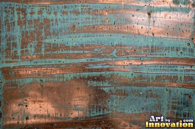 Oxidized copper with a mottled dark surface and bright scratches