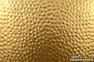 Crinkled gold leaf laid in overlapping squares with fine seams