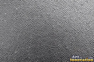 Stainless hammered metal tiles with a raised rim around each square
