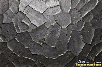 Planished metal with faint flat facets in a regular grid