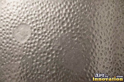 Stainless hammered metal tiles with a raised rim around each square