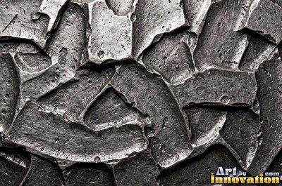 Hand hammered pewter sheet covered in overlapping round dimples