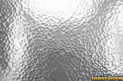 Planished metal with faint flat facets in a regular grid