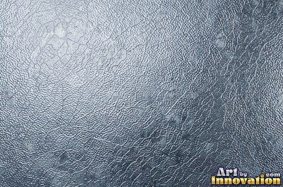 Large shallow hammer marks catching light like ripples on water