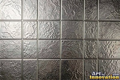 Hand hammered pewter sheet covered in overlapping round dimples