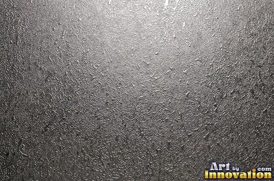 Hand hammered pewter sheet covered in overlapping round dimples