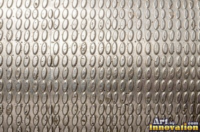Planished metal with faint flat facets in a regular grid