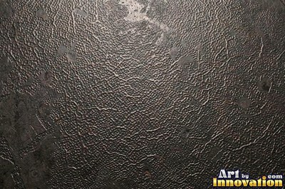 Stainless hammered metal tiles with a raised rim around each square