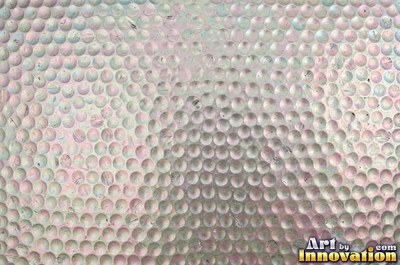 Planished metal with faint flat facets in a regular grid