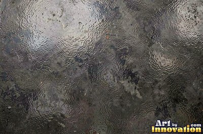 Hand hammered pewter sheet covered in overlapping round dimples