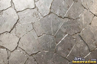 Stainless hammered metal tiles with a raised rim around each square