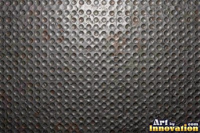 Hand hammered pewter sheet covered in overlapping round dimples