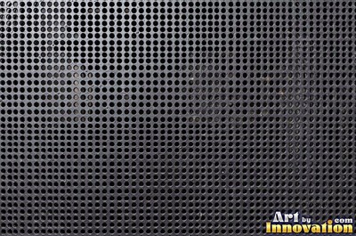 Perforated metal sheet with round holes in a tight grid of blackened iron