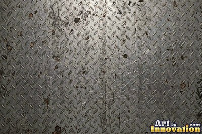 Perforated metal sheet with round holes in a tight grid of blackened iron