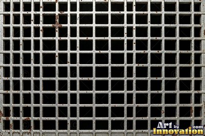 Perforated metal sheet with round holes in a tight grid of blackened iron