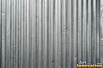 Perforated metal sheet with round holes in a tight grid of blackened iron
