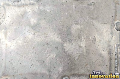 Welded steel surface with weld beads and grinding marks
