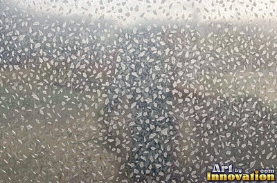 Perforated metal sheet with round holes in a tight grid of blackened iron