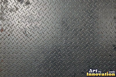 Perforated metal sheet with round holes in a tight grid of blackened iron