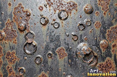 Rust bubbling up under old paint with blisters bursting open